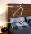 CPAP machine set up beside bed with hose holder holding hose