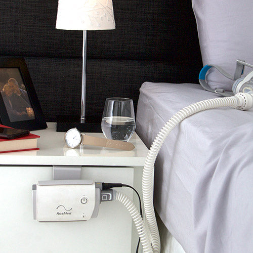 Caddy being used to secure Air mini on front of bedside table