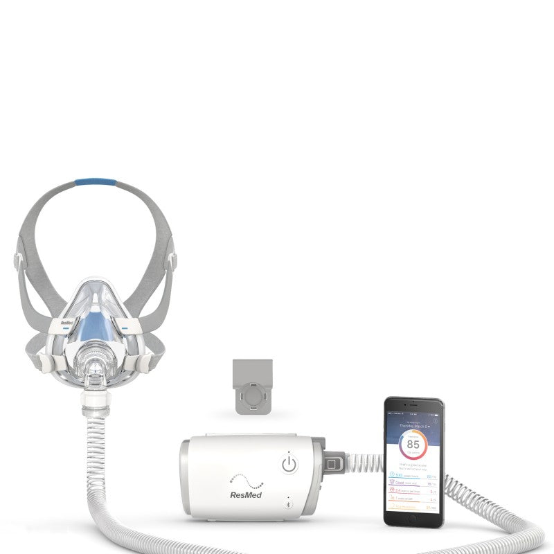 Resmed AirMini CPAP machine starter kit pictured with smartphone displaying Airnini app