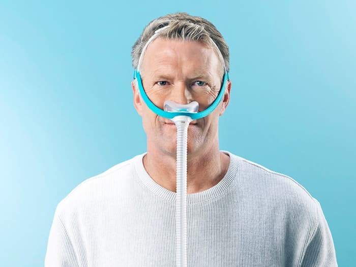 Man wearing the Fisher and Paykel Evora Nasal Mask