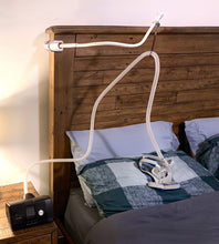 Load image into Gallery viewer, CPAP machine set up beside bed with hose holder holding hose