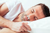 Man sleeping wearing Bongo Rx Sleep Therapy Device