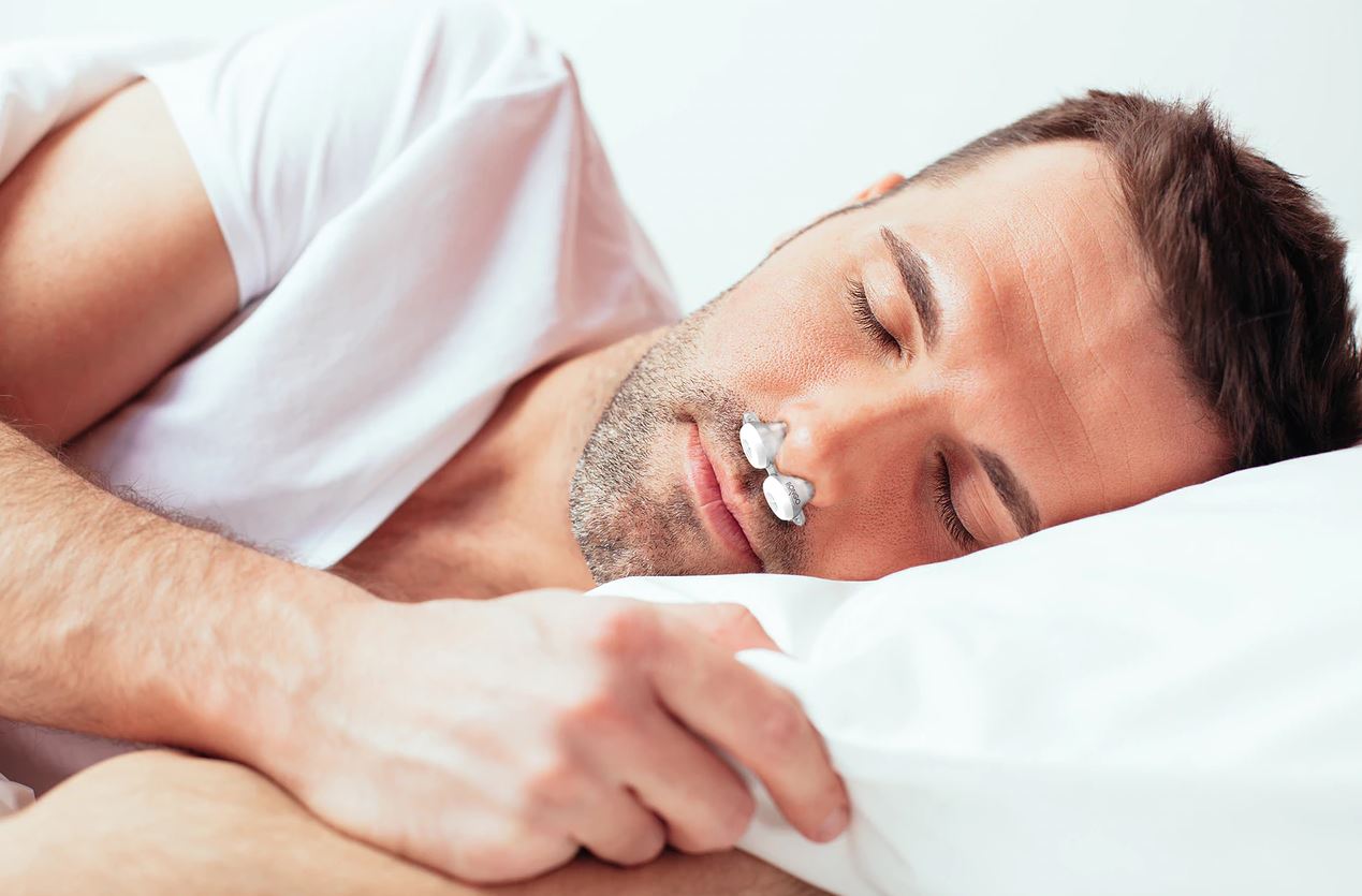 Man sleeping wearing Bongo Rx Sleep Therapy Device