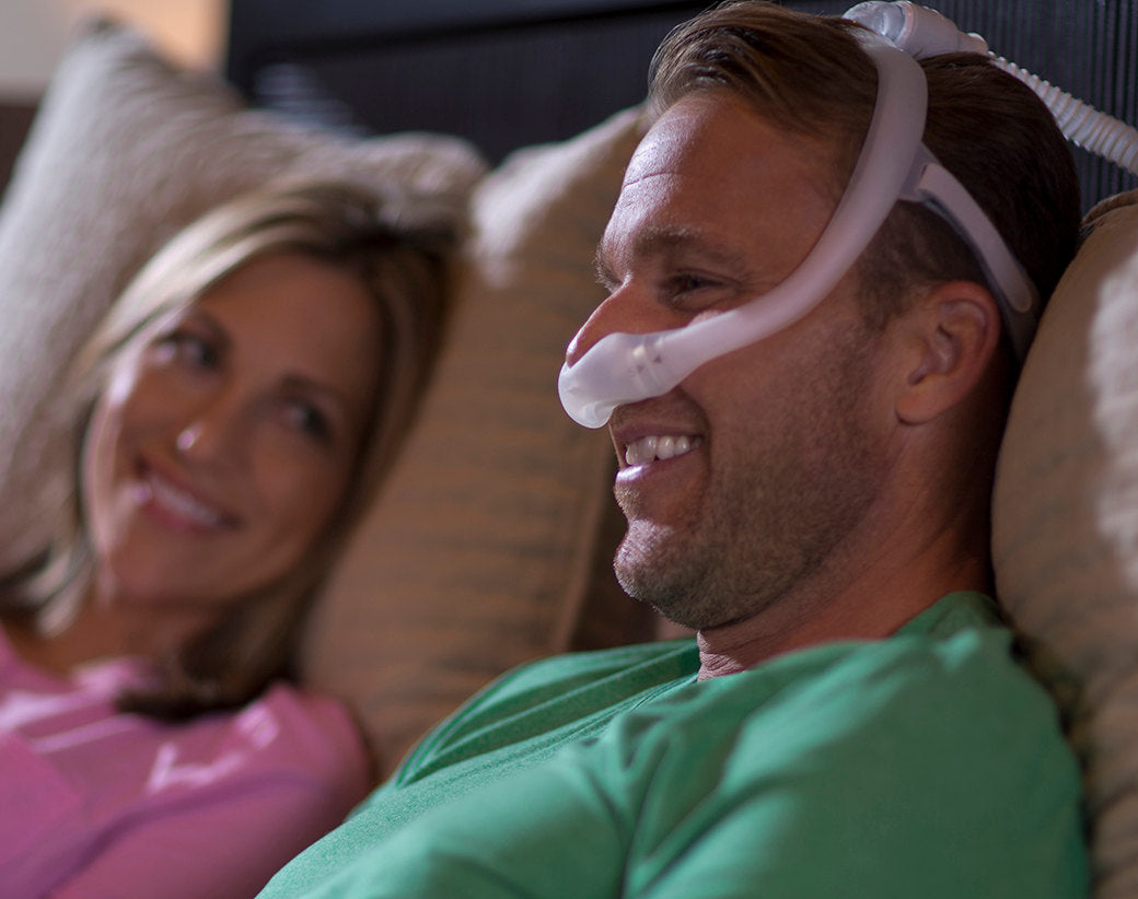 Man smiling wearing Philips Respironics DreamWearunder the nose mask