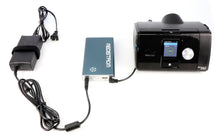 Load image into Gallery viewer, Pilot 24 battery connected to AC adapter and Airsense 10 CPAP machine
