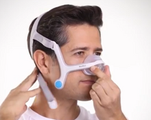 Load image into Gallery viewer, Man putting on the ResMed Airfit N20 Nasal Mask